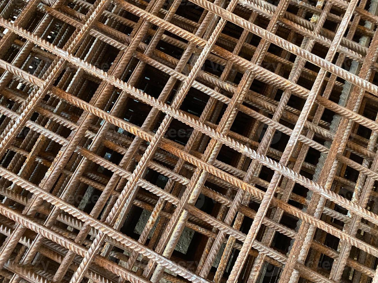 Iron rusty bars of wire reinforcement for building houses and producing industrial reinforced concrete at a construction site photo