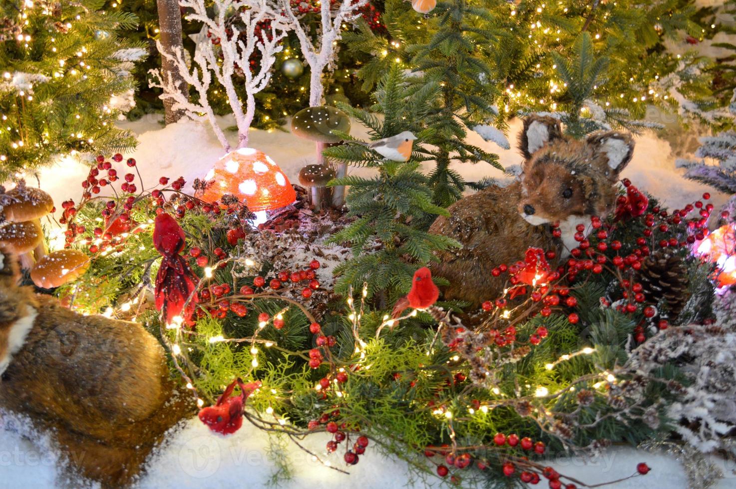 Bullfinch And Berries Toy Decoration On The Branches Of A Christmas Tree photo