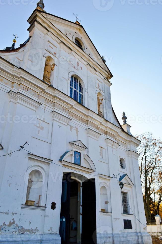 Old ancient white poor stone shabby Christian Orthodox church with crosses photo