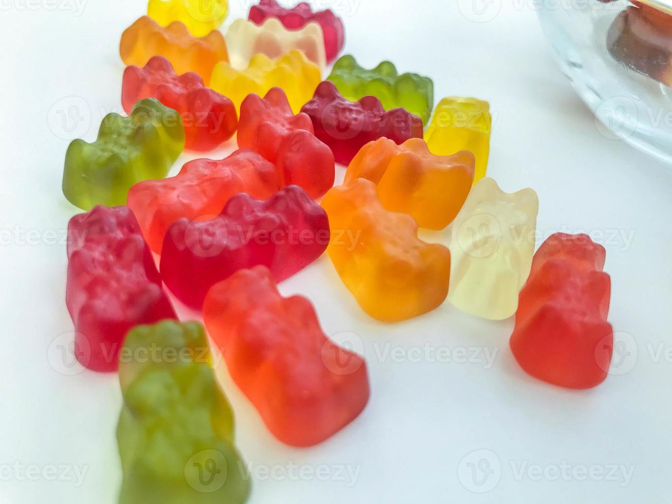 gelatinous, multi-colored, volumetric bears on a white matte background. mouth-watering and sweet candies. natural edible sweets. dessert made from juices and pomace photo