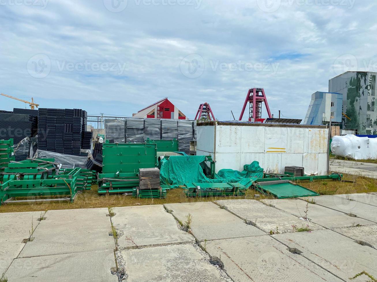 A large outdoor warehouse at a construction site, a warehouse for industrial equipment and materials in boxes at an open-air storage site photo