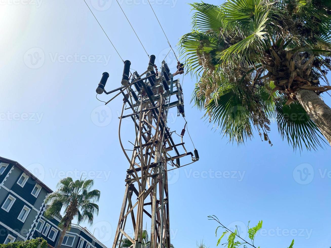 High high-voltage industrial electrical tower with wires for supplying electricity to consumers photo