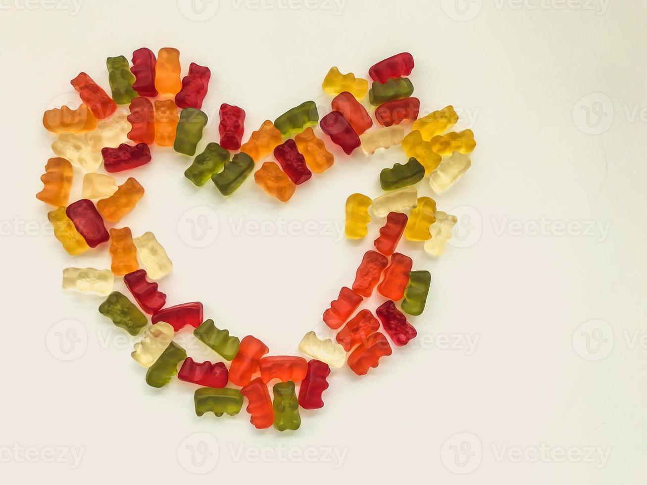 heart made of colored marmalade. Valentine's Day. cute symbol of love and happiness made from sweet and tasty candies. candies from marmalade of different shapes. mouth-watering dessert photo