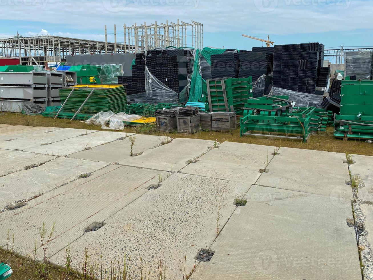 A large outdoor warehouse at a construction site, a warehouse for industrial equipment and materials in boxes at an open-air storage site photo