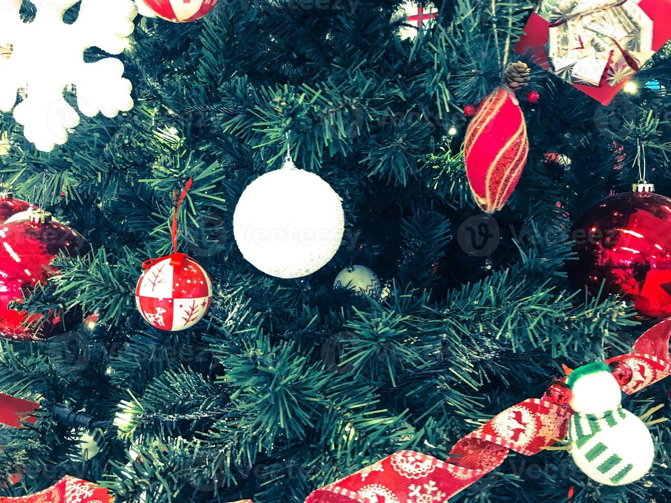 Festive multicolored beautiful shiny fancy balls, toys, gift boxes, decorations on the Christmas green tree with needles and branches for the New Year. Background, texture photo