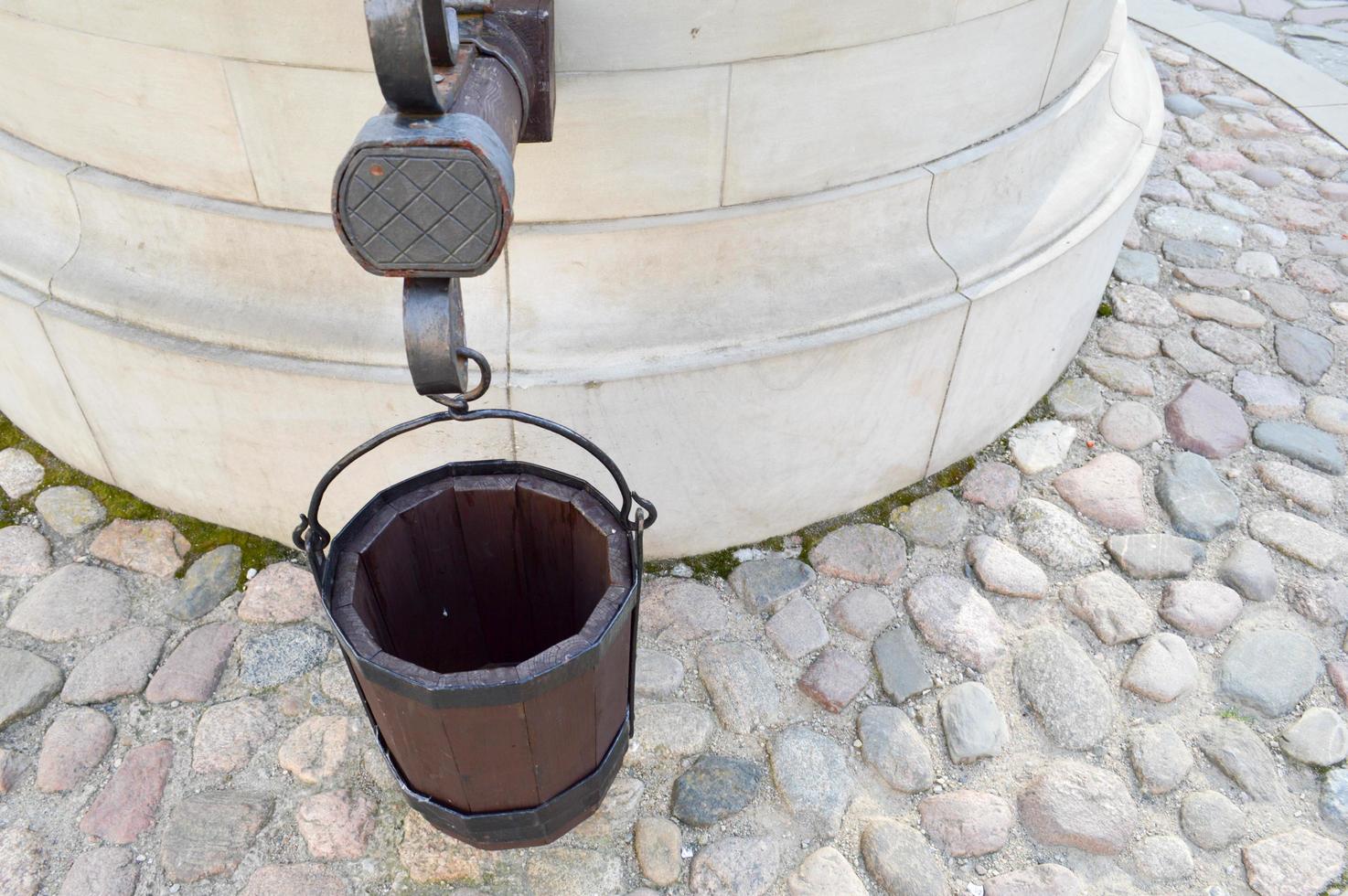 Large round old ancient stone well with buckets for water photo