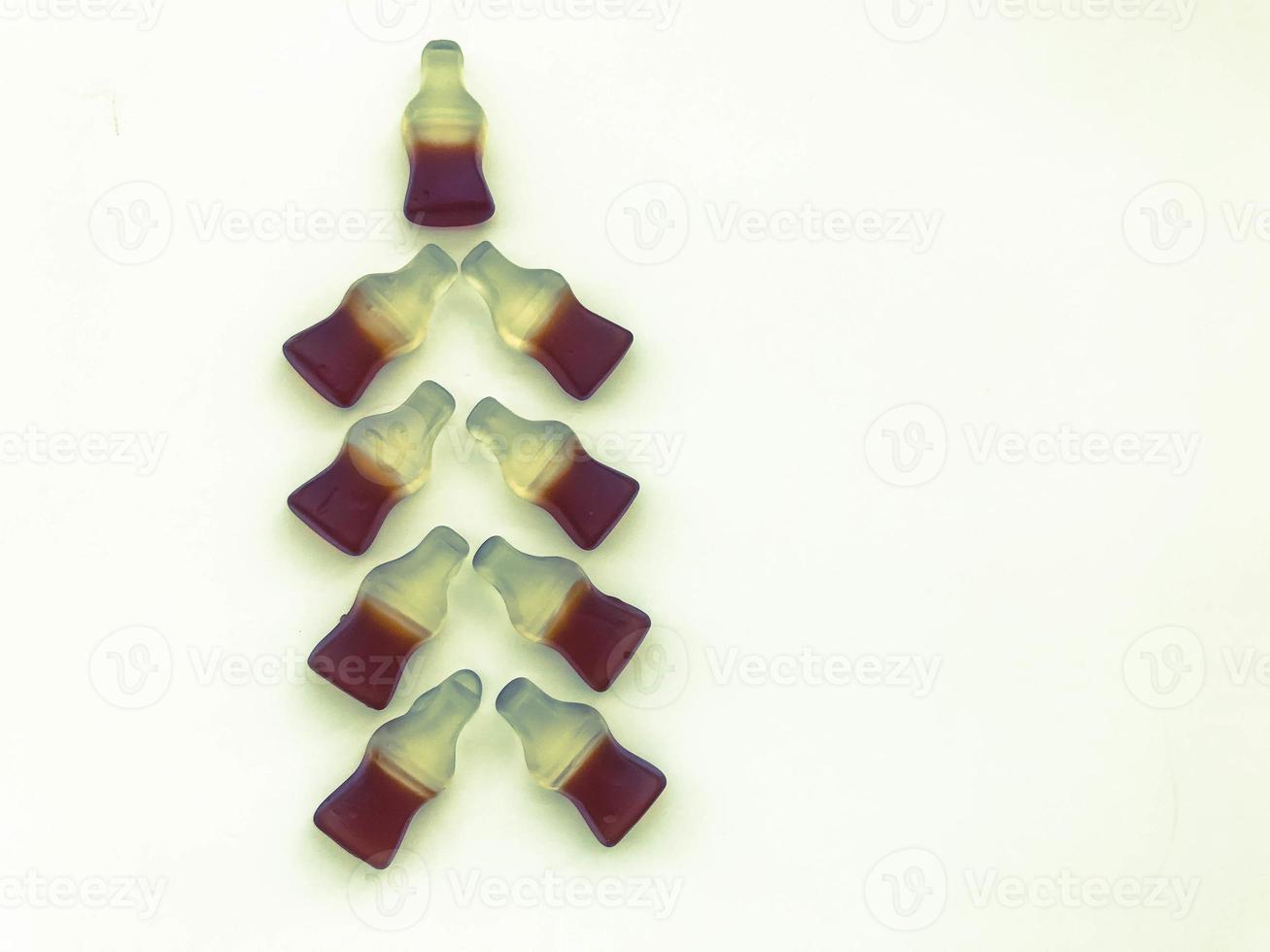 Christmas tree made from gummy bottles with lemonade on a white matte background. unusual Christmas tree made of sweets. a Christmas gift photo