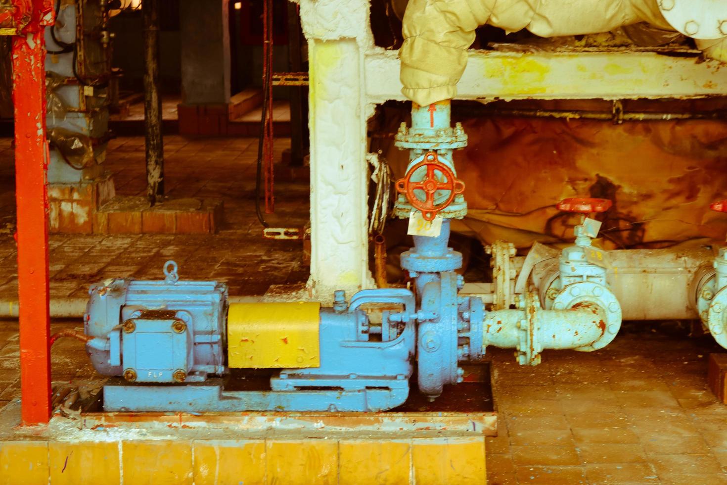 Iron metal centrifugal pumps equipment and pipes with flanges and valves for pumping liquid fuel products at the industrial refinery chemical petrochemical plant shop photo