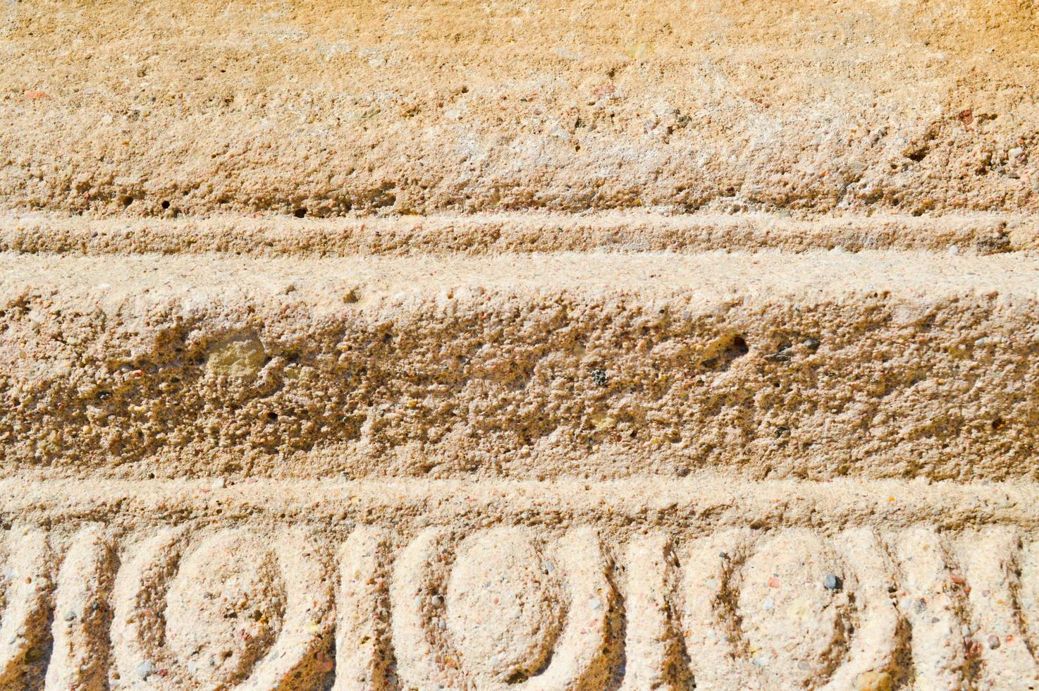 The texture of the yellow sand stone of old stone with patterns and stripes. The background photo