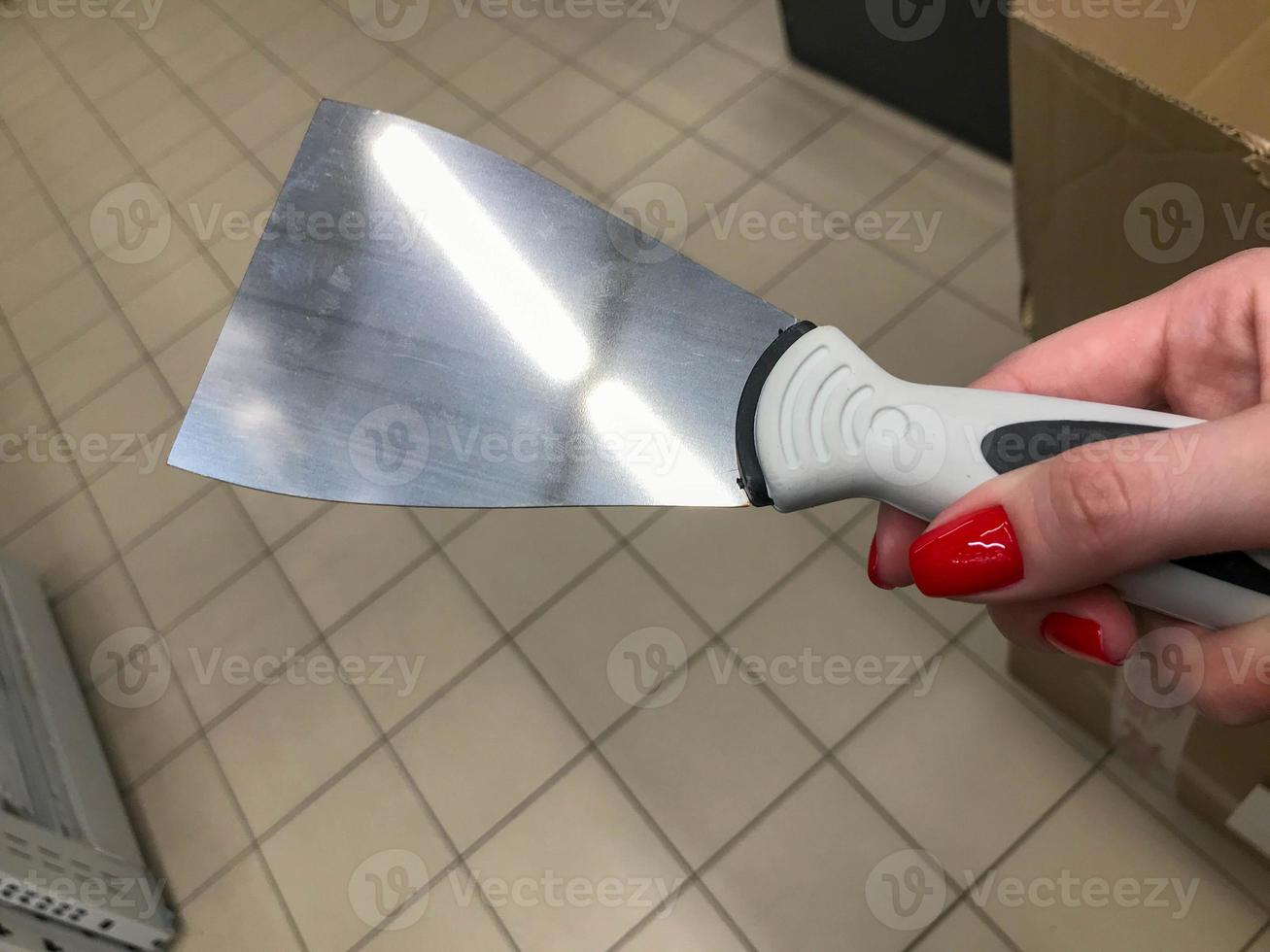 construction notched trowel and worker hands photo