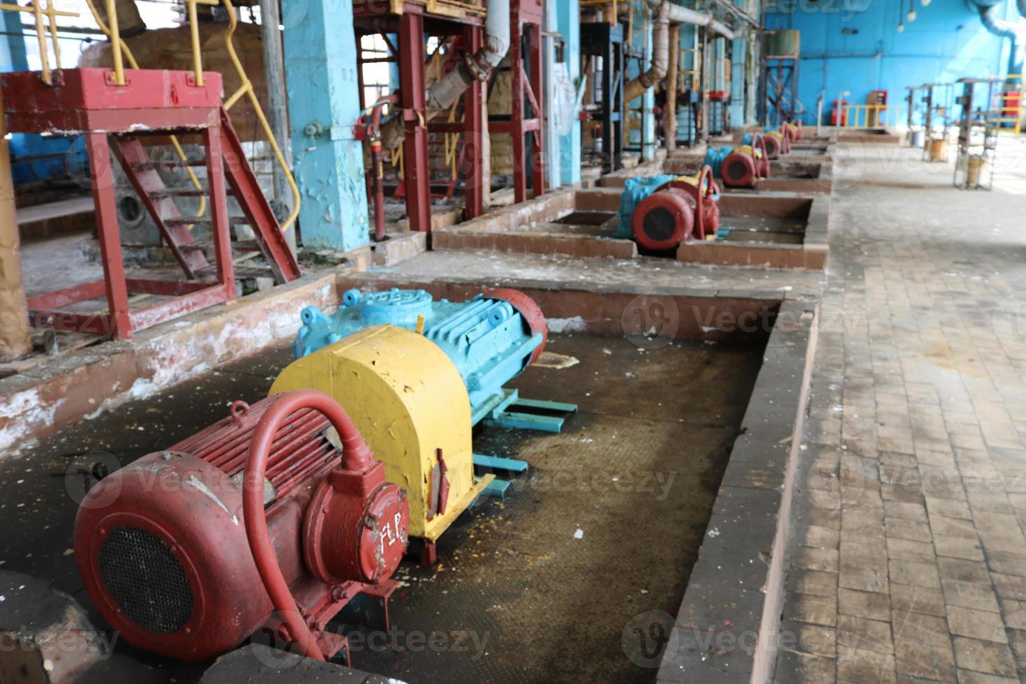 Iron metal centrifugal pumps equipment and pipes with flanges and valves for pumping liquid fuel products at the industrial refinery chemical petrochemical plant shop photo