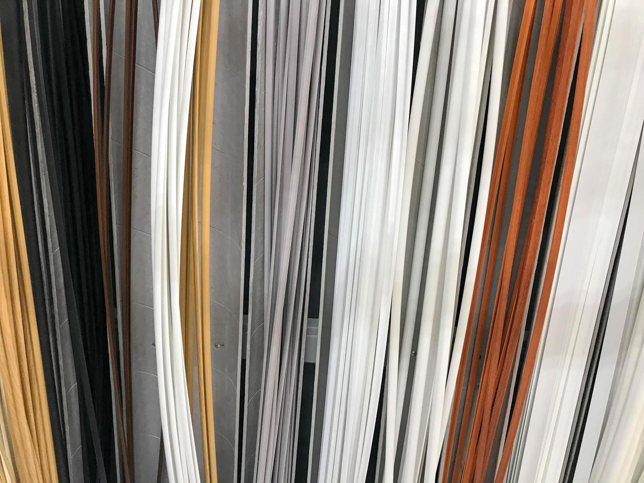 The texture of the plastic building interior decorative baseboards multi-colored with the color of wood. The background photo