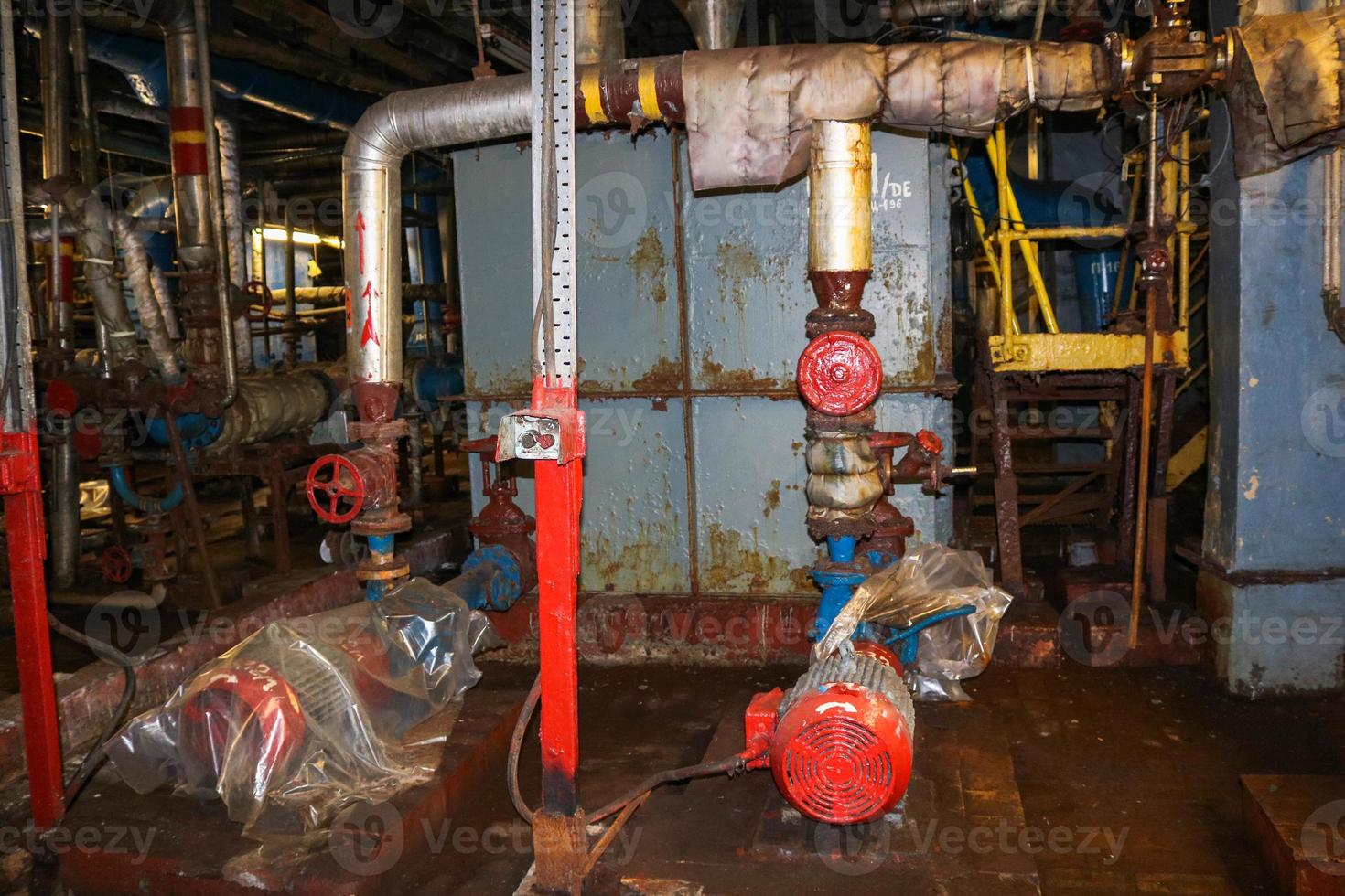 Iron metal centrifugal pumps equipment and pipes with flanges and valves for pumping liquid fuel products at the industrial refinery chemical petrochemical plant shop photo