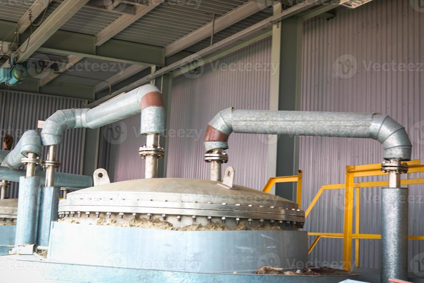 Stainless steel metal lid with bolts and studs, top of the heat exchanger of a chemical rectification column with a pipe with flanges at an industrial refinery petrochemical plant photo