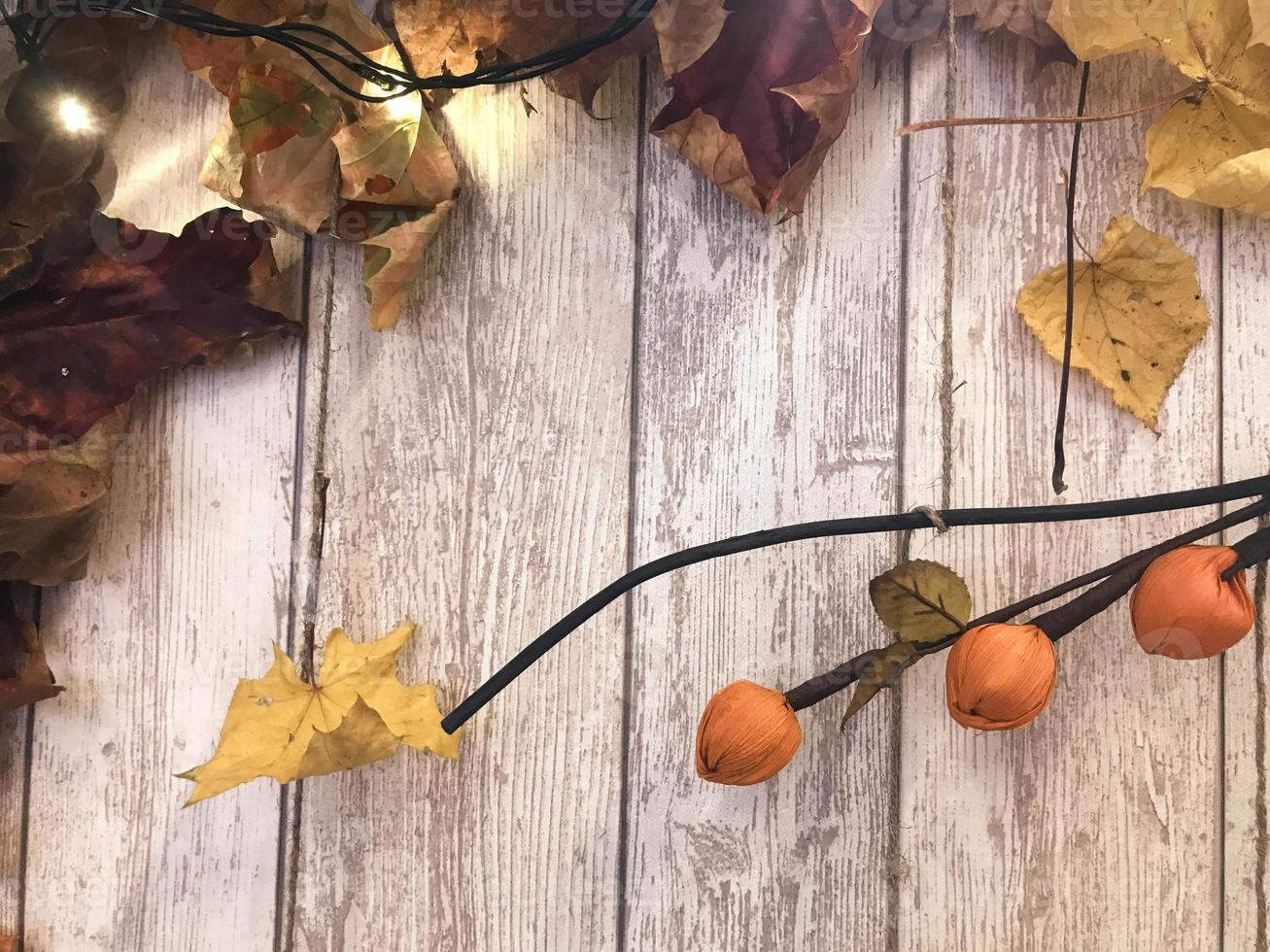 Frame and yellow red brown colorful natural autumn leaves, maple on the background of wooden boards. The background. Texture photo