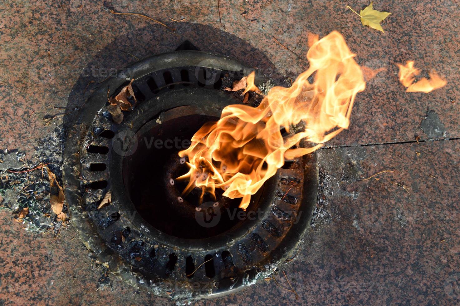 Orange is a beautiful warm hot eternal flame burning from the ground in memory of deceased warriors, soldiers photo