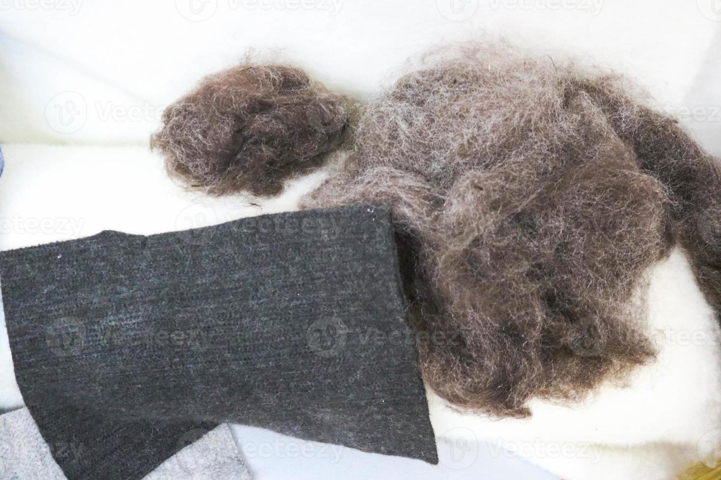 Lumps of gray pile, wool, wool yarn, raw materials for felted toys, demonstration of fiber production on a white background photo