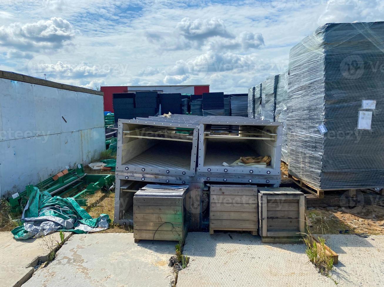 A large outdoor warehouse at a construction site, a warehouse for industrial equipment and materials in boxes at an open-air storage site photo