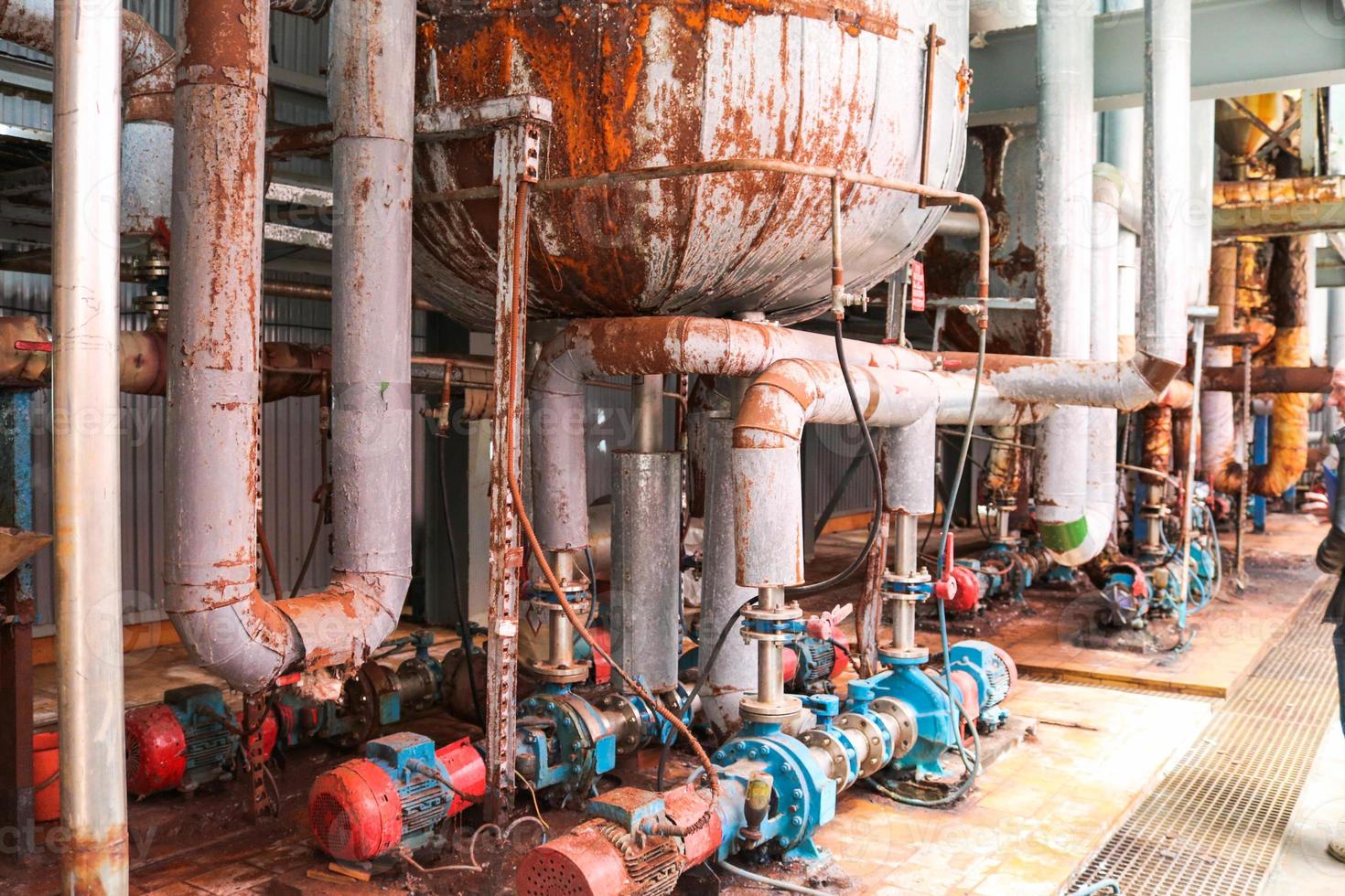 Iron metal centrifugal pumps equipment and pipes with flanges and valves for pumping liquid fuel products at the industrial refinery chemical petrochemical plant shop photo