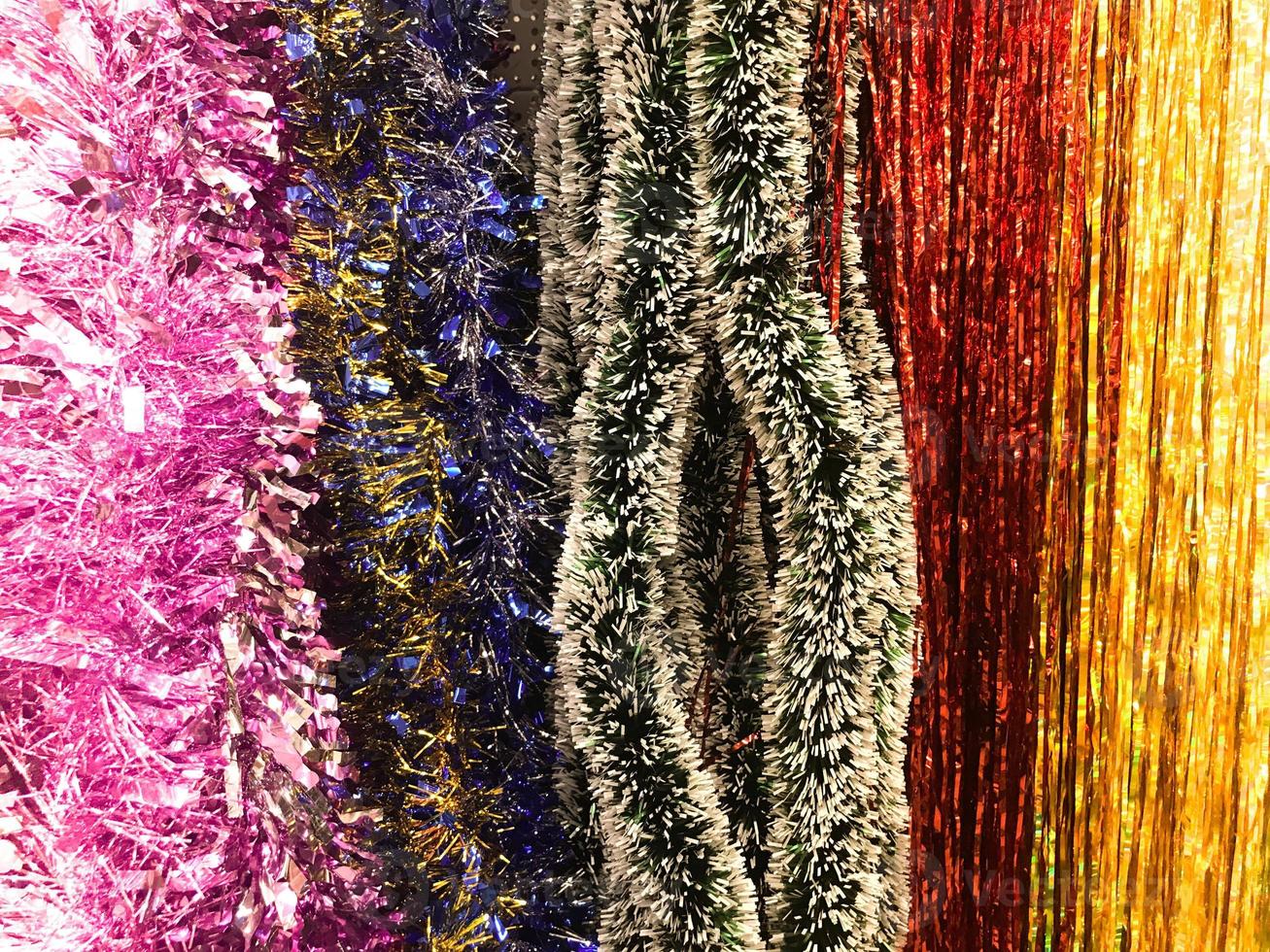 Festive multicolored rainbow shiny silver beautiful Christmas plastic garland sparkling for the New Year, Christmas-tree tinsel, festively decorated. Texture. Background photo