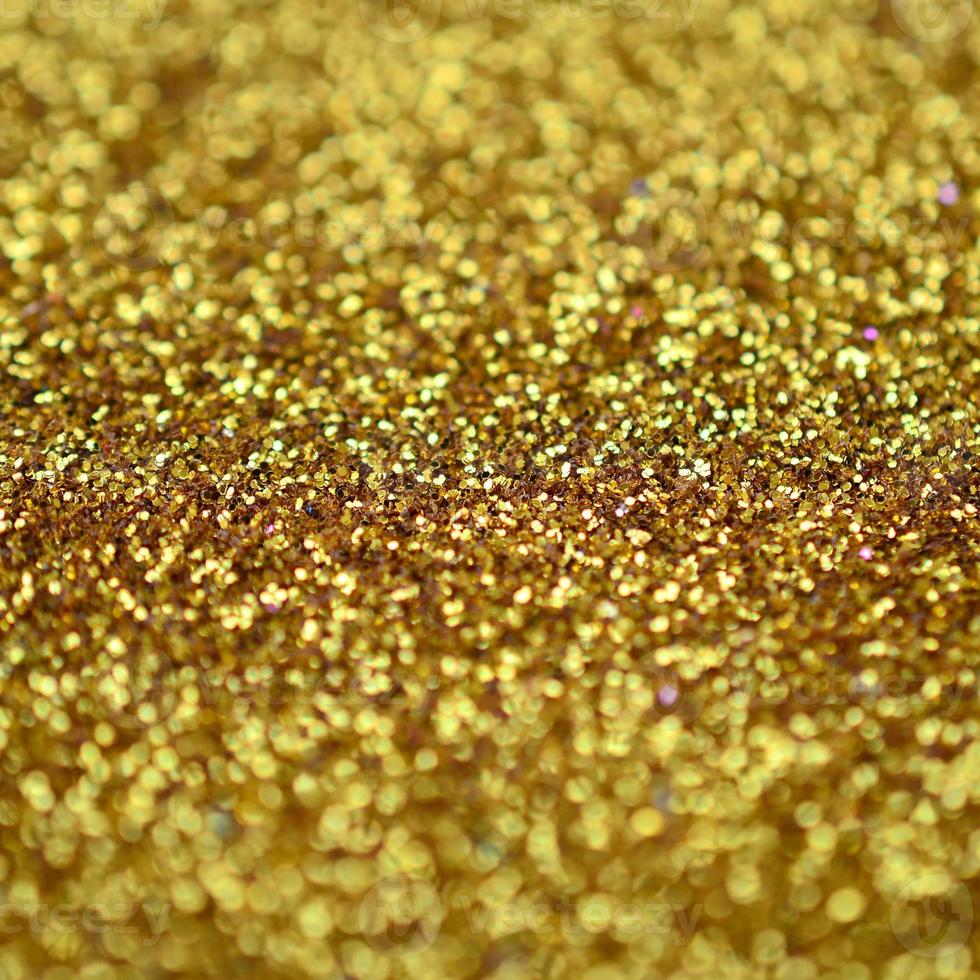 Orange decorative sequins. Background image with shiny bokeh lights from small elements photo