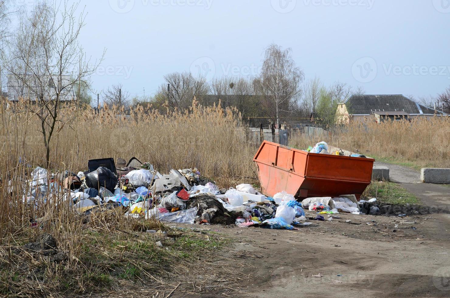 The garbage can is packed with garbage and waste. Untimely removal of garbage in populated areas photo