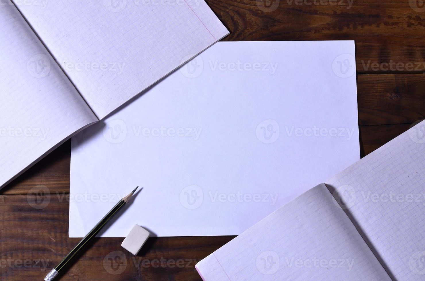 Photo of a clean white school checkbook on a brown wooden background. Idea or message concept. Plenty of space for text