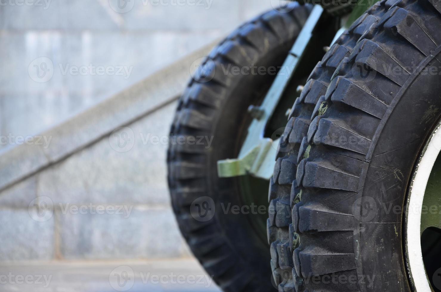 A close-up wheels of a portable weapon of the Soviet Union of World War II, painted in a dark green photo