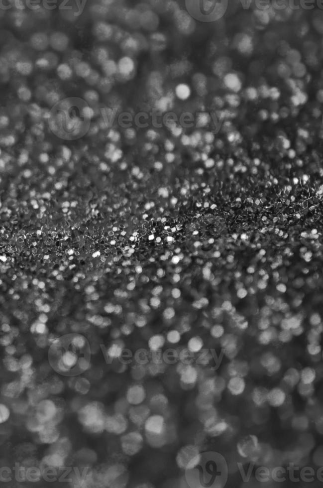 Silver decorative sequins. Background image with shiny bokeh lights from small elements photo