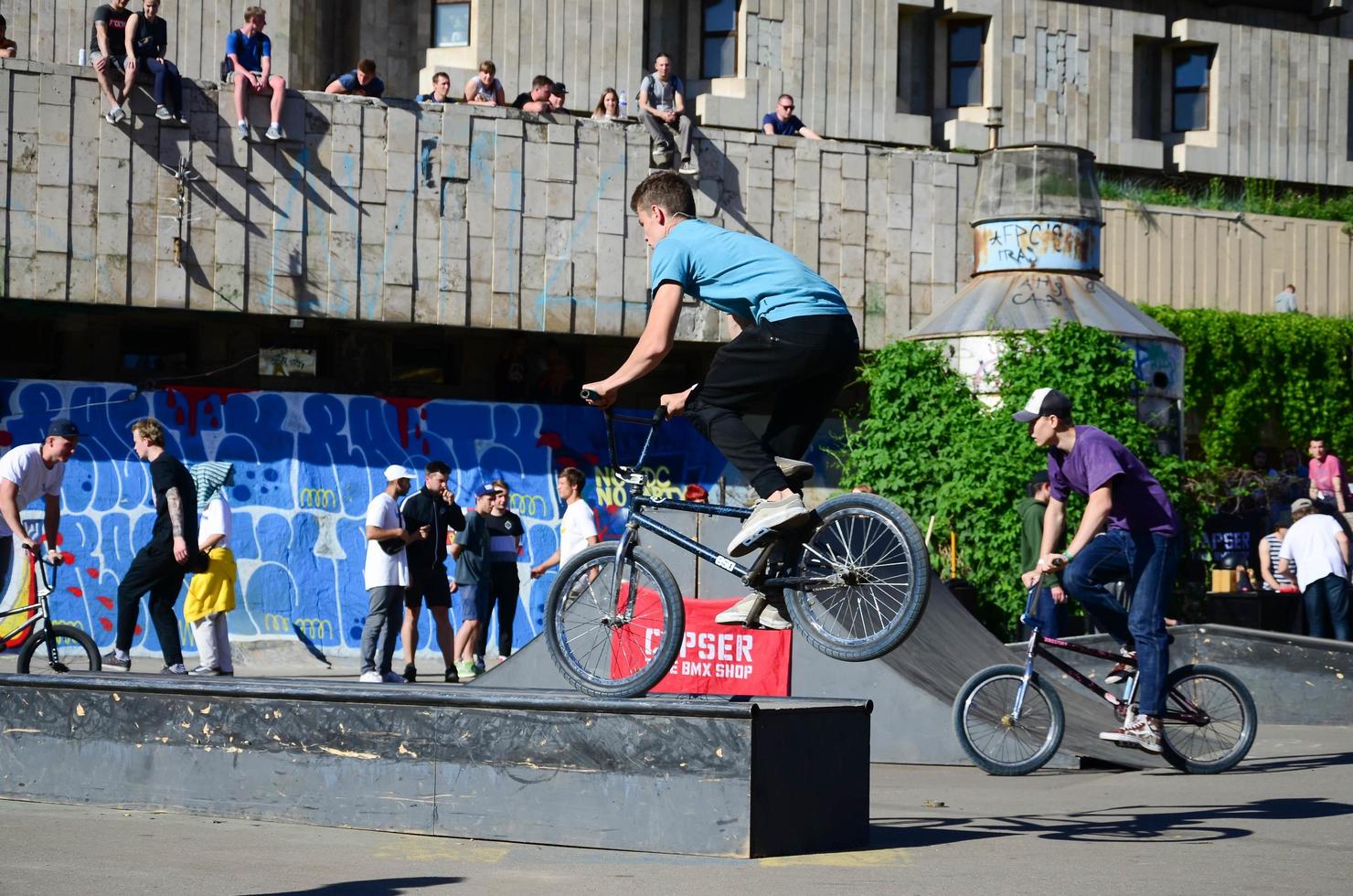 KHARKIV, UKRAINE - 27 MAY, 2018 Freestyle BMX riders in a skatepark during the annual festival of street cultures photo