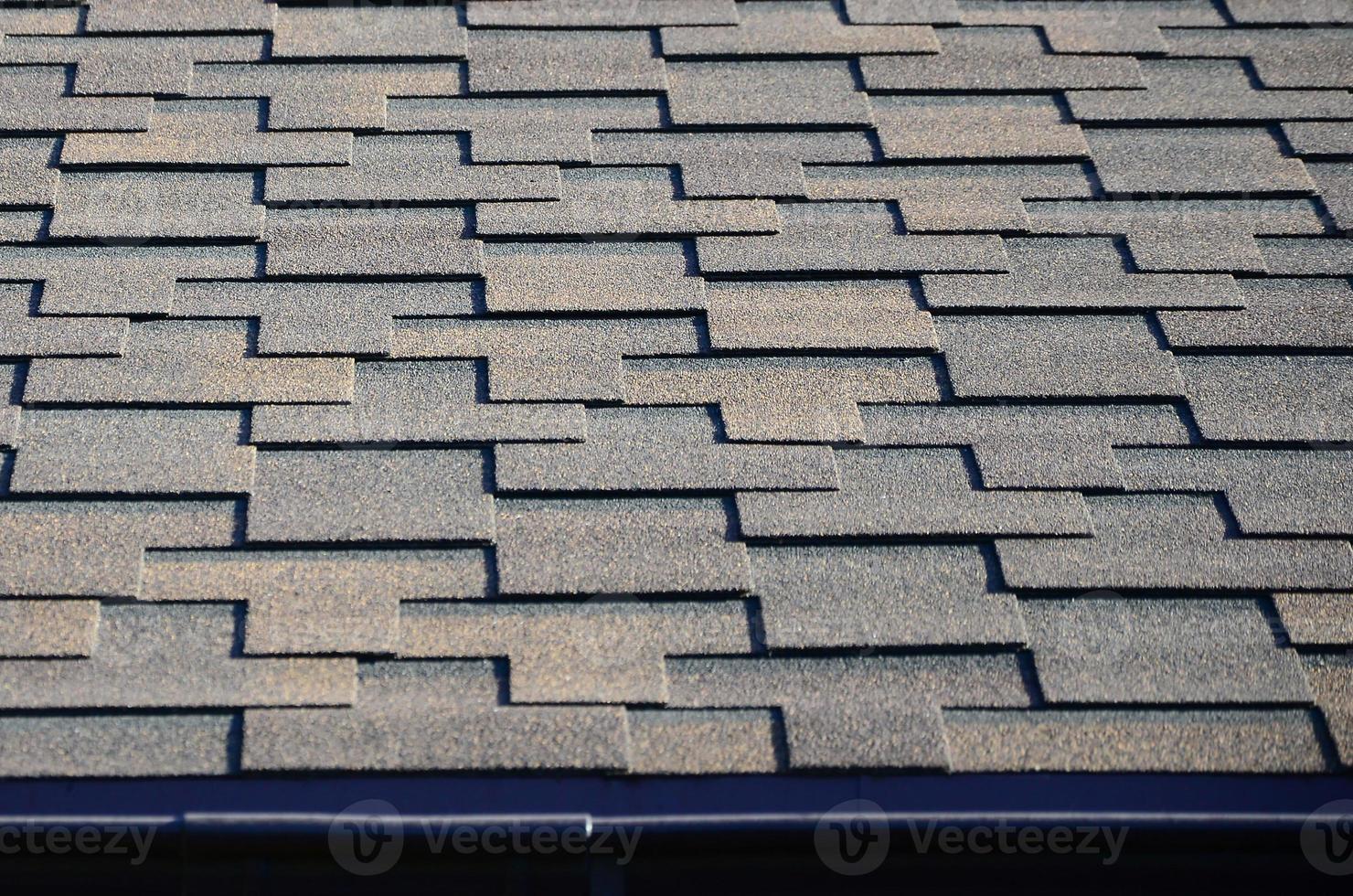 Modern roofing and decoration of chimneys. Flexible bitumen or slate shingles photo