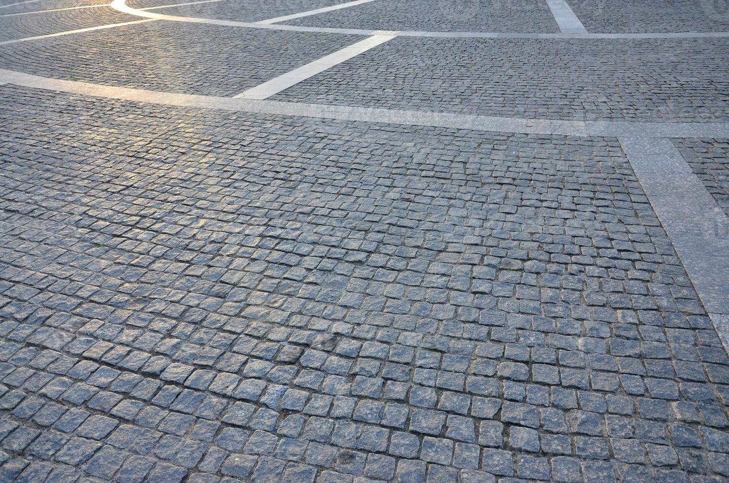 Fragment of the street square, folded out of a gray square paving stone photo