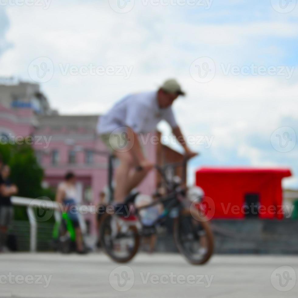 Defocused image of a lot of people with bmx bikes. Meeting of fans of extreme sports photo