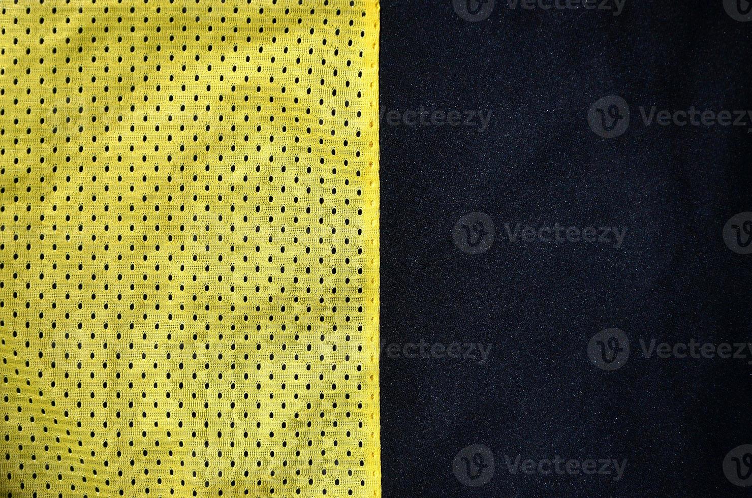 Sport clothing fabric texture background. Top view of yellow polyester nylon cloth textile surface. Colored basketball shirt with free space for text photo