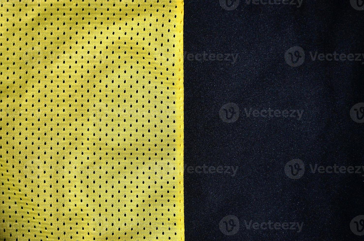 Sport clothing fabric texture background. Top view of yellow polyester nylon cloth textile surface. Colored basketball shirt with free space for text photo