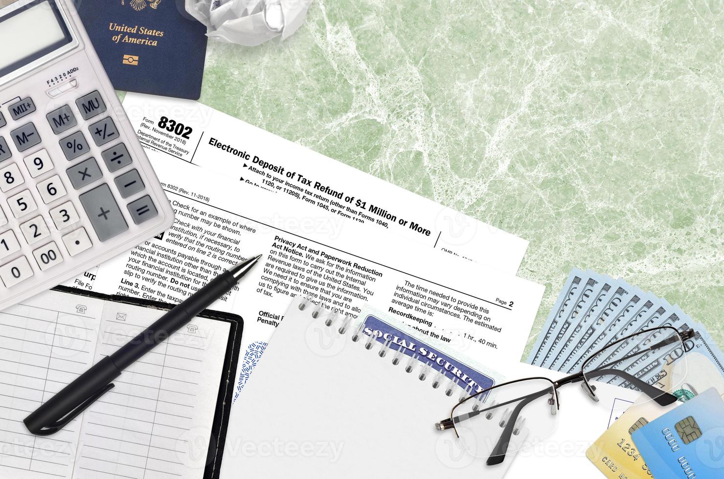 IRS form 8302 Electronic deposit of tax refund of 1 million or more lies on flat lay office table and ready to fill. U.S. Internal revenue services paperwork concept photo