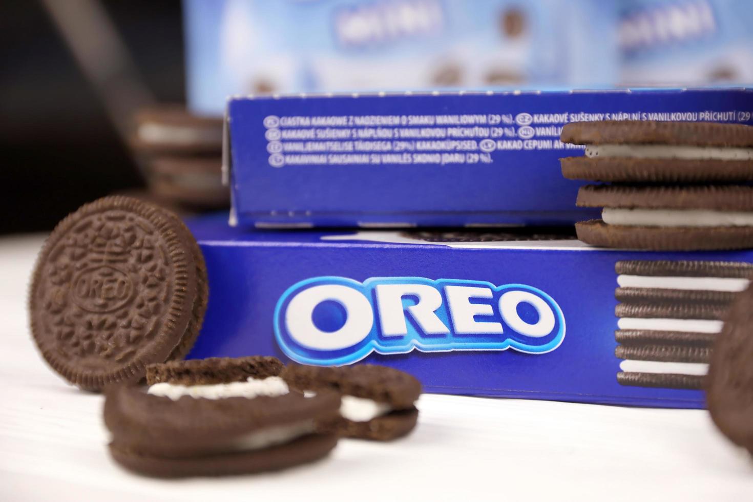 KHARKOV. UKRAINE - MAY 2, 2019 Oreo sandwich cookies and blue product boxes on white table. Oreo is a sandwich cookie with a sweet cream is the best selling cookie in the US photo