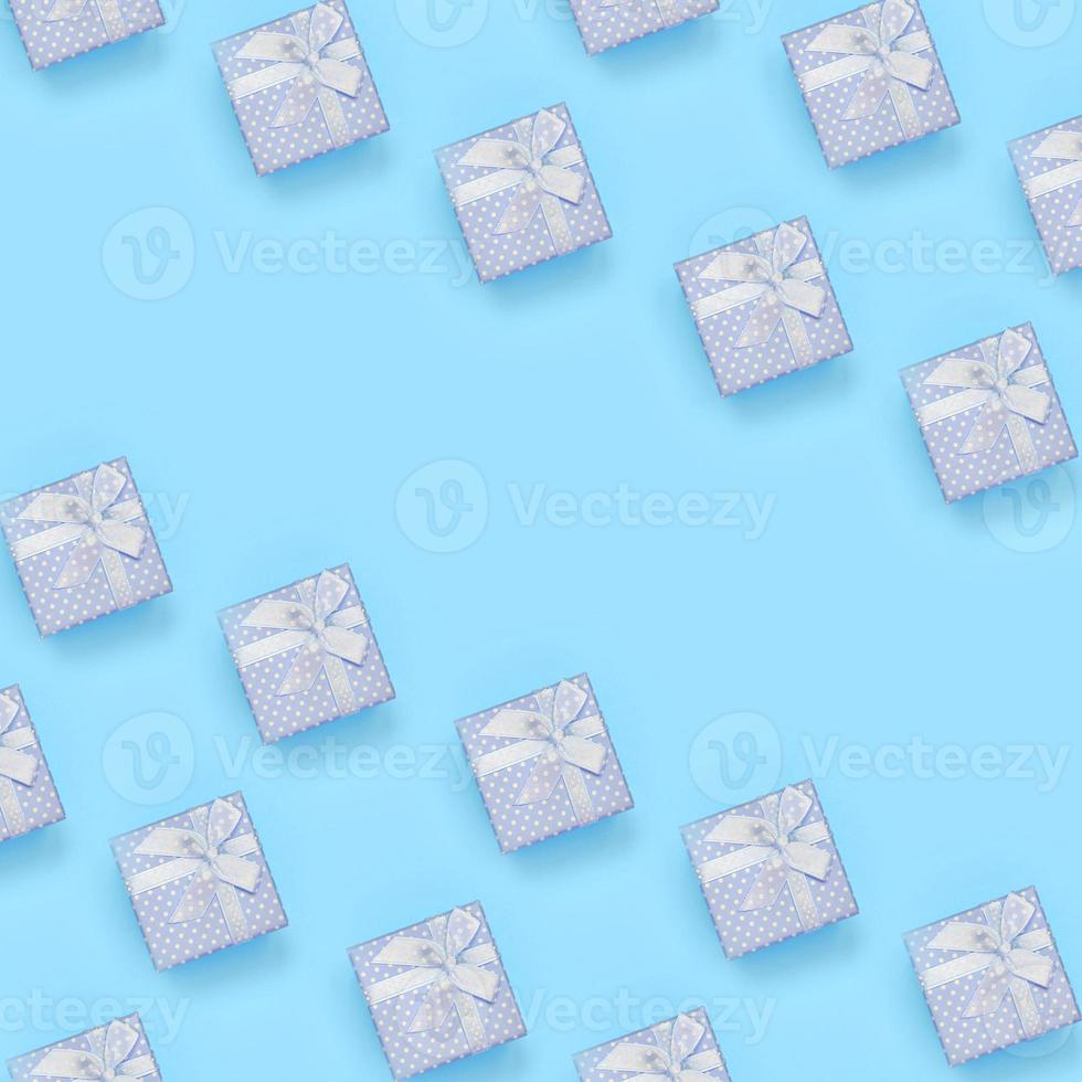 A lot of blue gift boxes lies on texture background of fashion pastel blue color paper in minimal concept photo