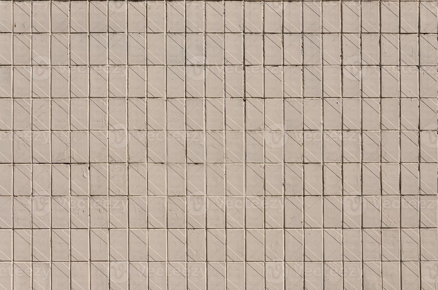 Old Soviet beige wall tiles. The texture of the classical outer tile, which was revetted by buildings during the times of the Soviet Union photo
