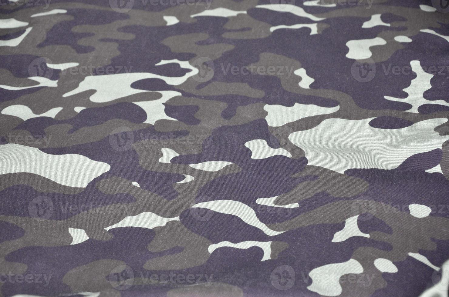 Texture of fabric with a camouflage painted in colors of the marsh. Army background image photo