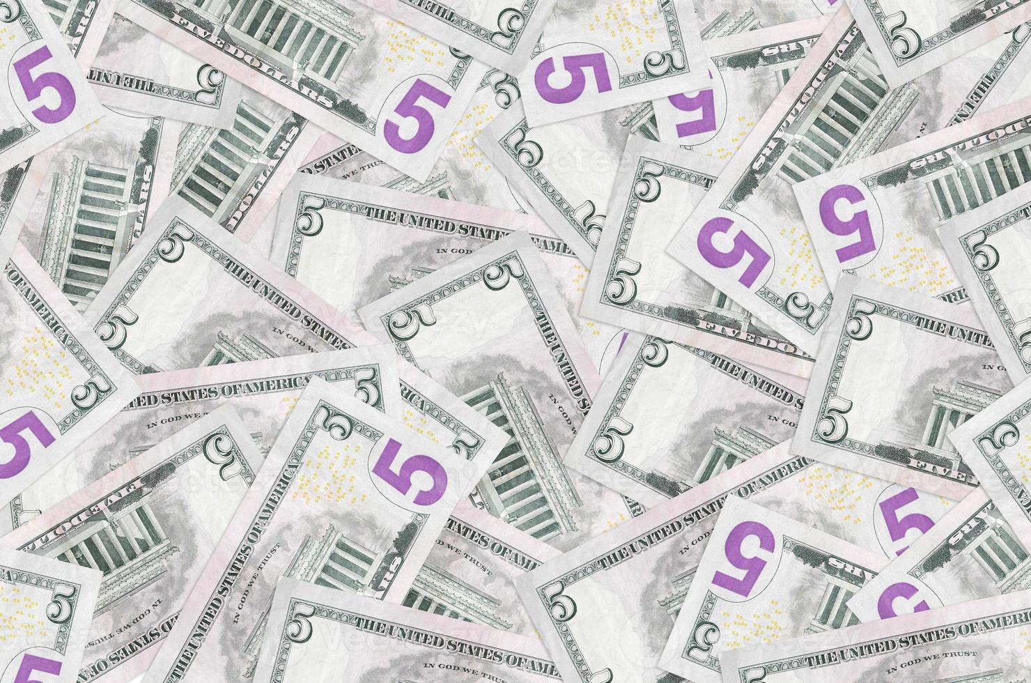 5 US dollars bills lies in big pile. Rich life conceptual background photo