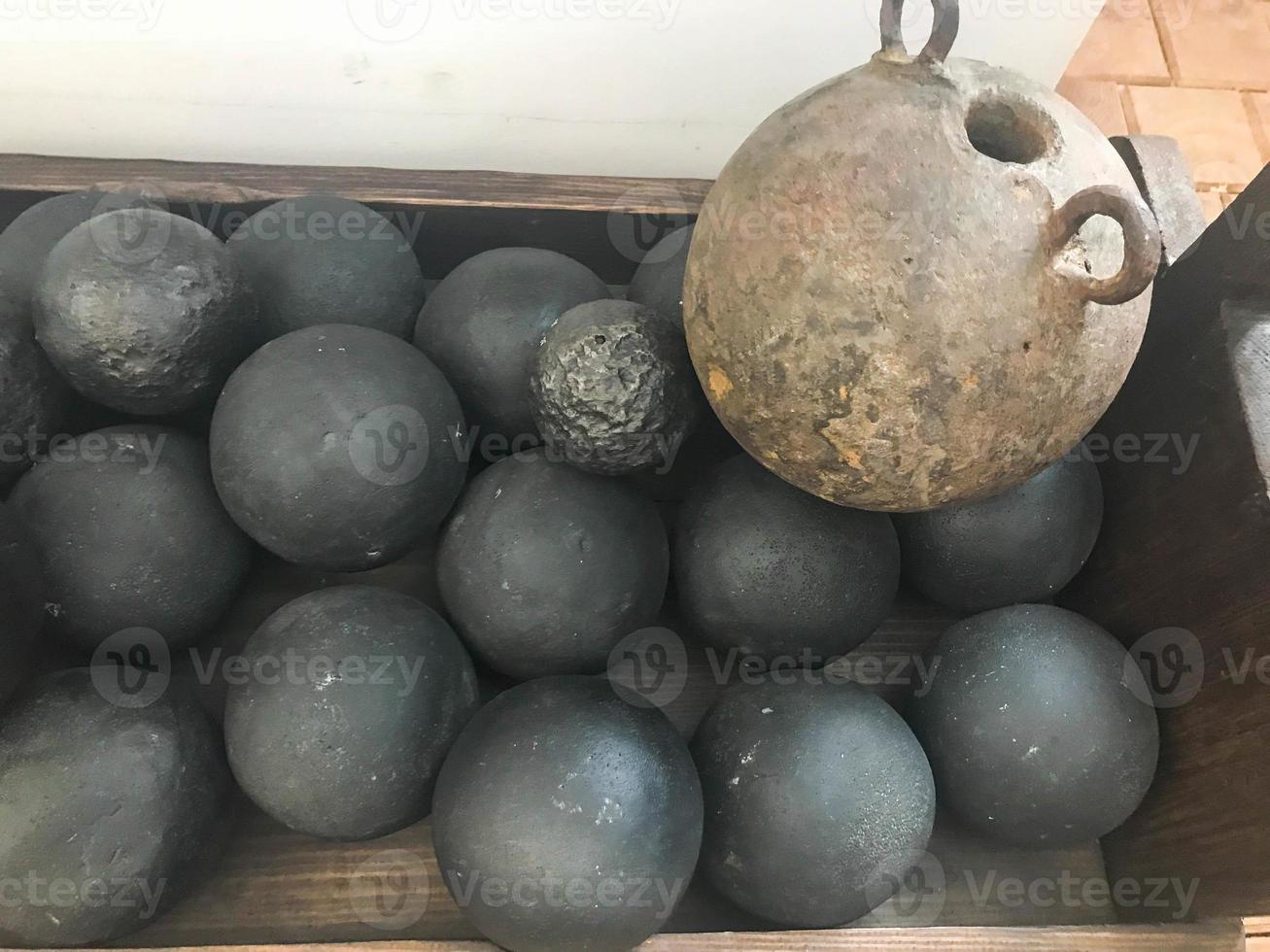 Texture of old antique combat round gray metallic, iron, stone cannon balls, ammunition. The background photo