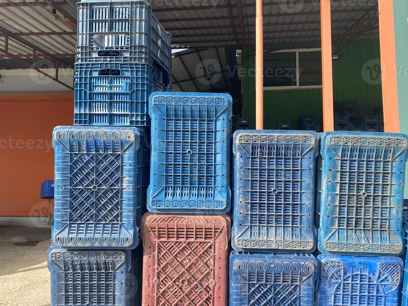 Large multi-colored plastic boxes for goods and products stand as a wall in a warehouse photo