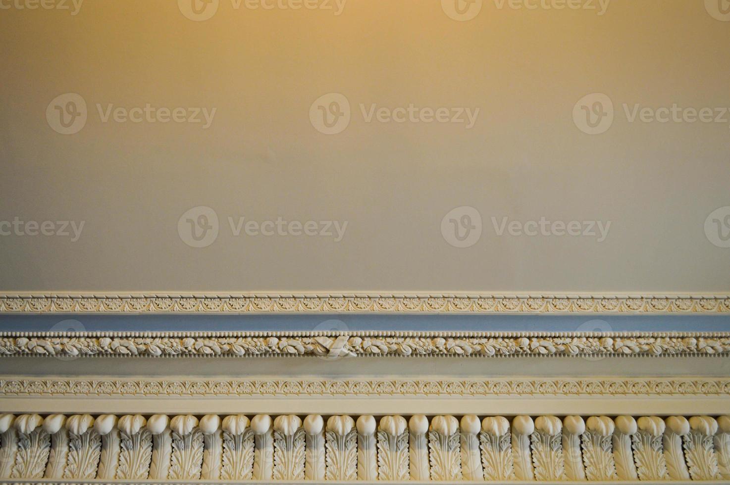 Texture of white stone ceiling with patterns and beautiful plaster moldings. The background photo