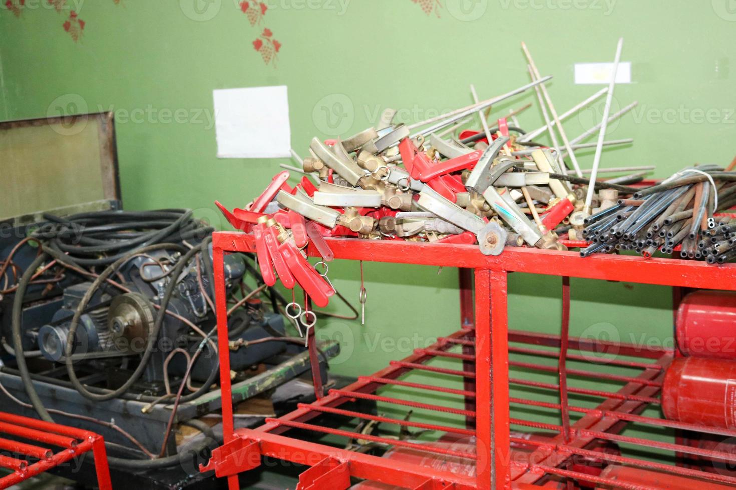 Spare parts for fire extinguishers at the refueling station of fire extinguishers, locking-starting devices, pipes and cylinders at an industrial plant photo