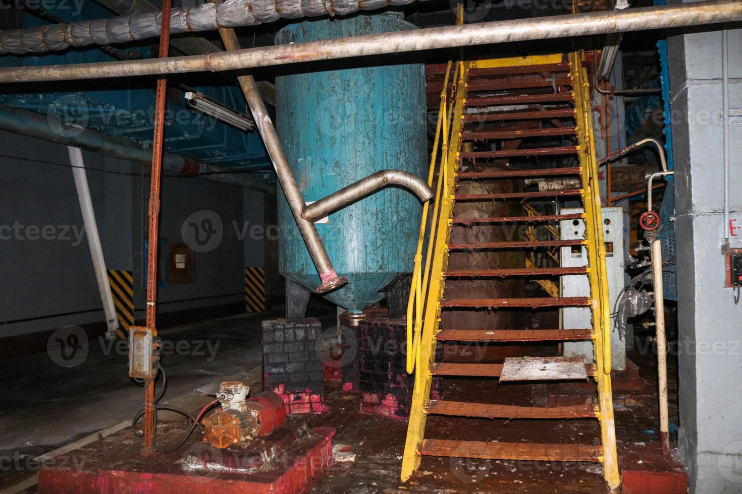 Stairs with steps and shelves with railings and equipment tanks at the industrial refinery chemical petrochemical photo
