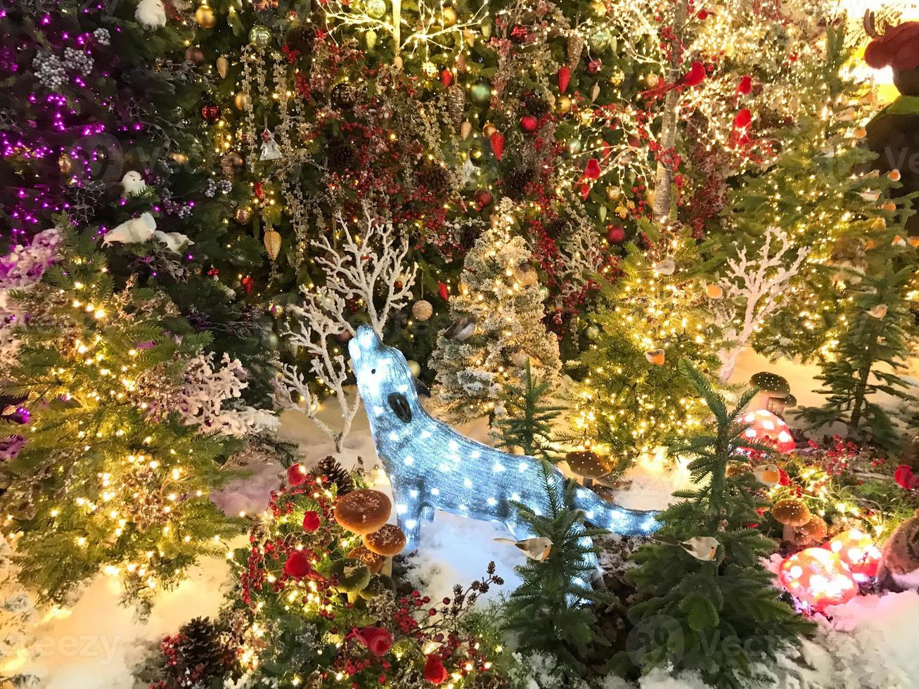 A festively decorated Christmas tree with bows, balls and garlands photo