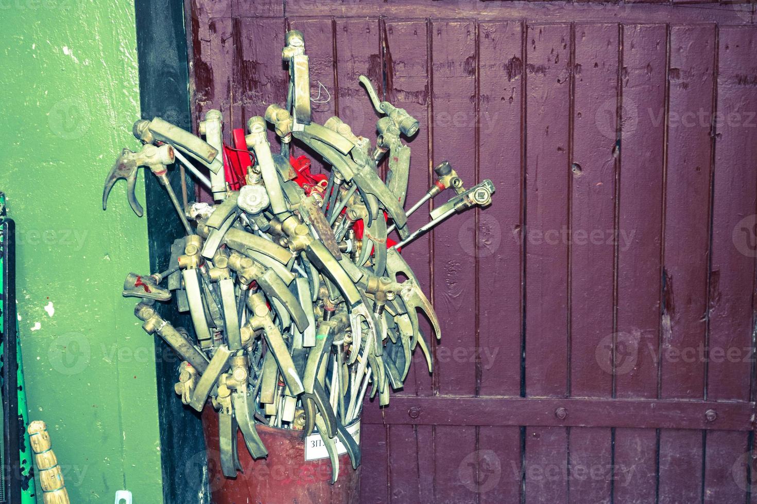 Spare parts for fire extinguishers at the refueling station of fire extinguishers, locking-starting devices, pipes and cylinders at an industrial plant photo