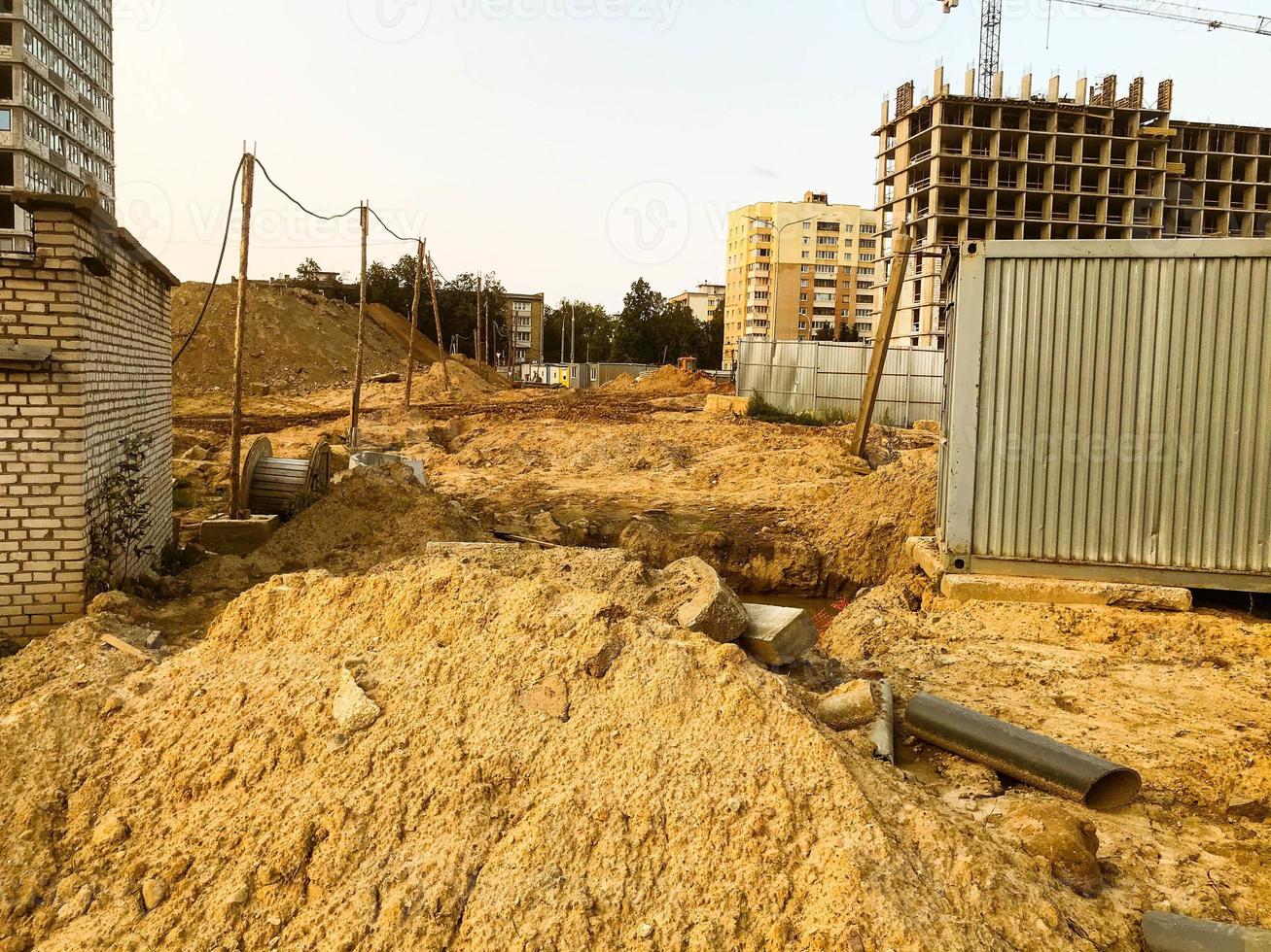 there is a lot of sand on the construction site. a moat was dug for sewerage. creation of drains to drain water underground. groundwater treatment, care for the environment photo