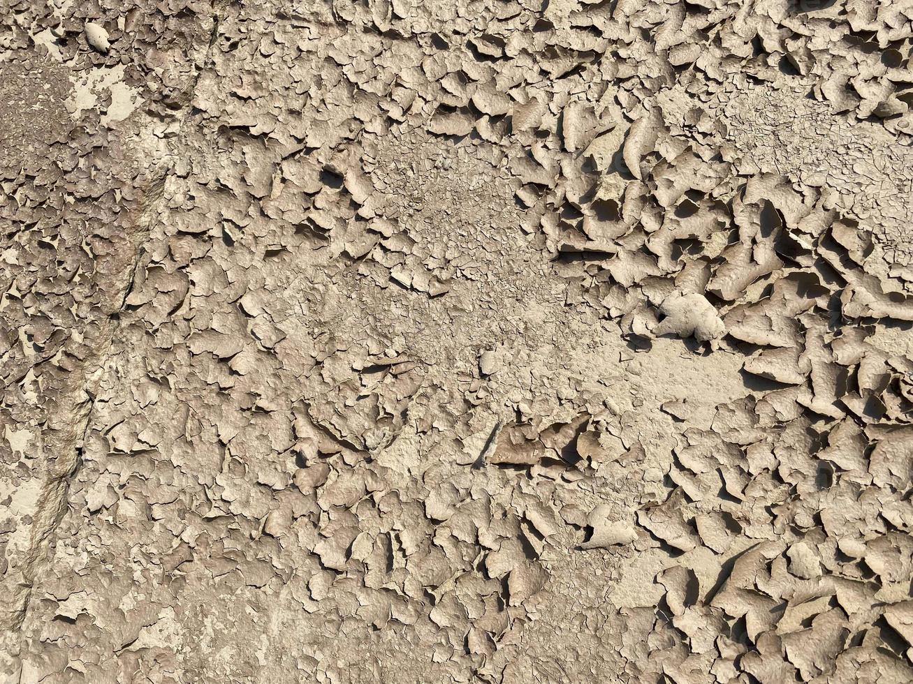 Texture of brown dry cracked flaky dirt and ground with sand. Background, texture photo
